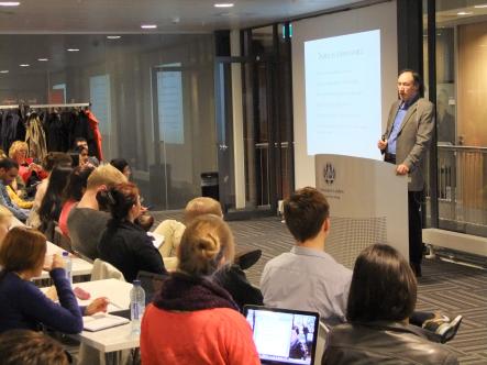 The audience listens attentively to Marc Chavannes 